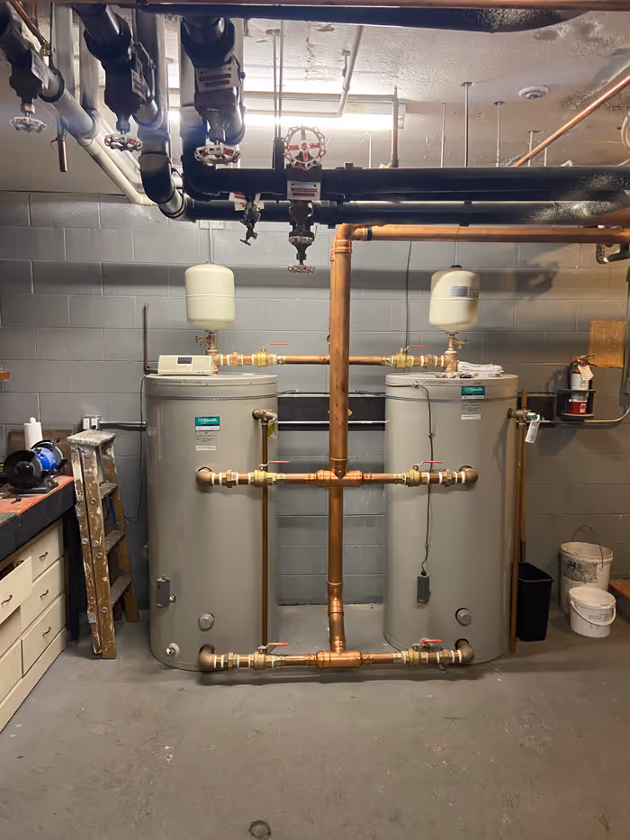 Hot water tanks part of a complex plumbing and heating system. 
